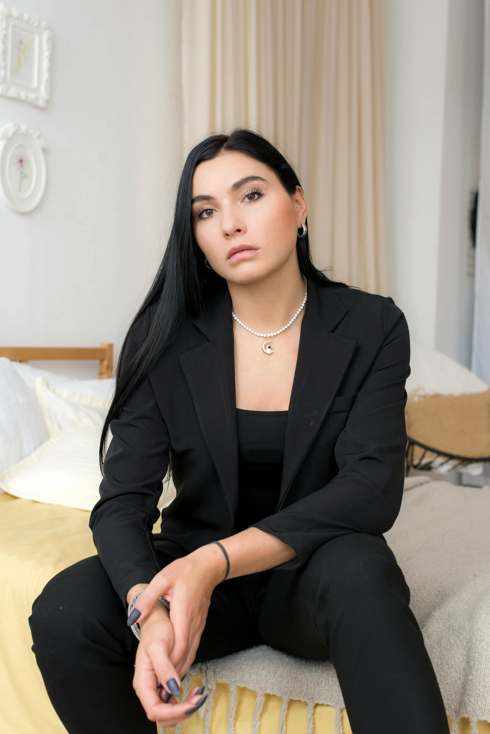 a woman in black sitting on the floor with one foot propped up