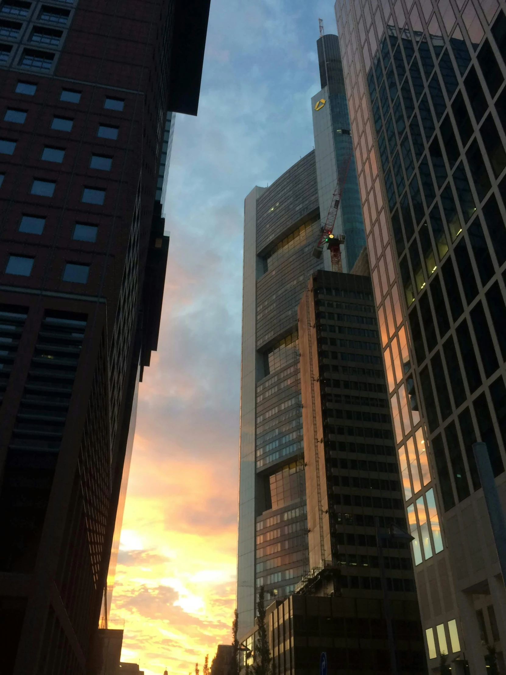 a building in a city with the sun going down in the distance