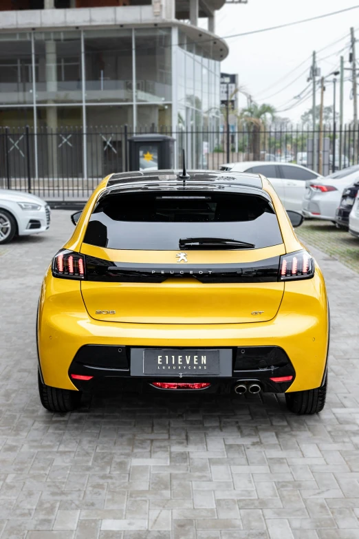 the yellow car is parked next to a building