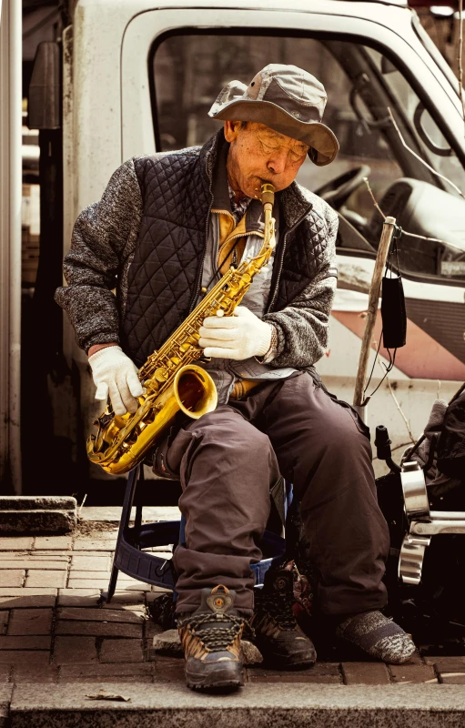 an old man sitting in a chair playing a saxophone