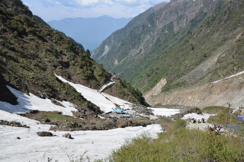 a mountain valley that has people walking down it