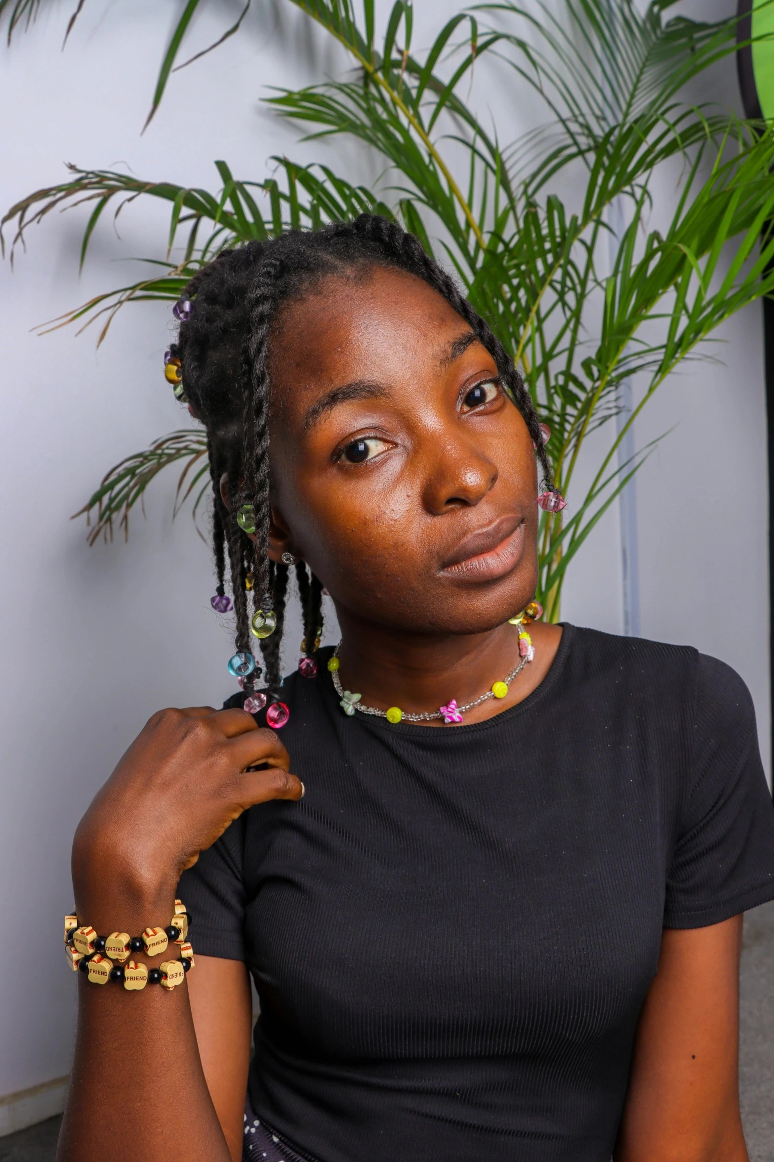 a woman holding a plant and wearing earrings