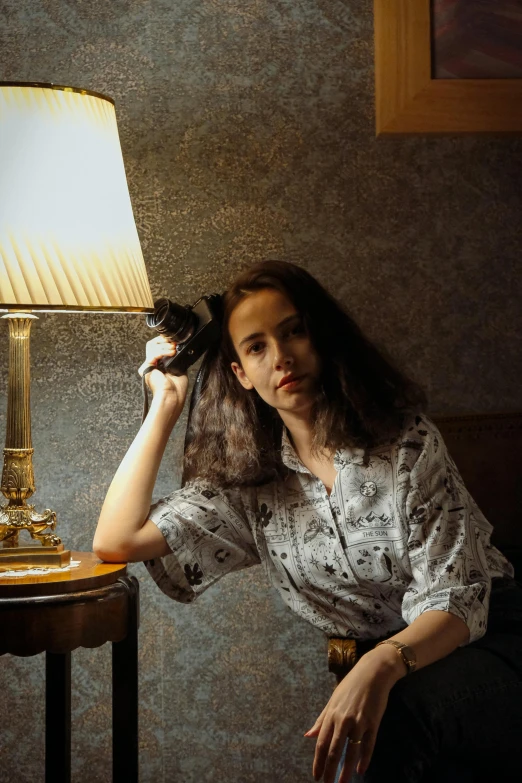 a woman sitting on a chair looking at the camera with a stuffed animal in her arms