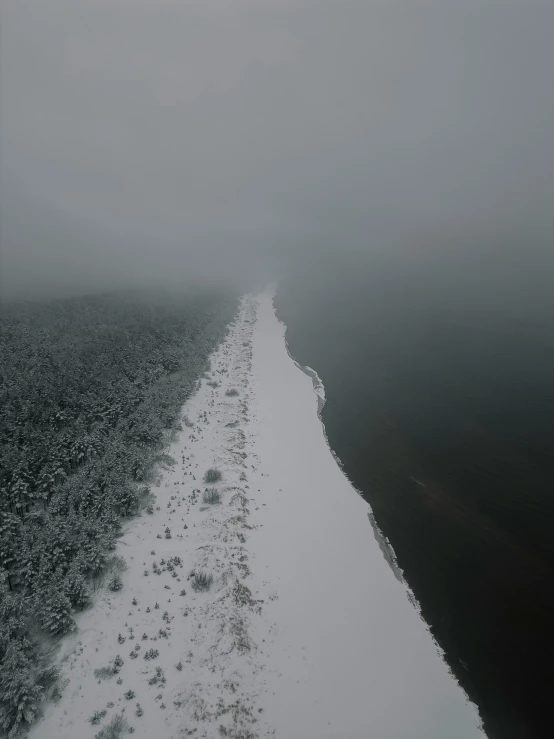 a wide empty path leads to a foggy horizon