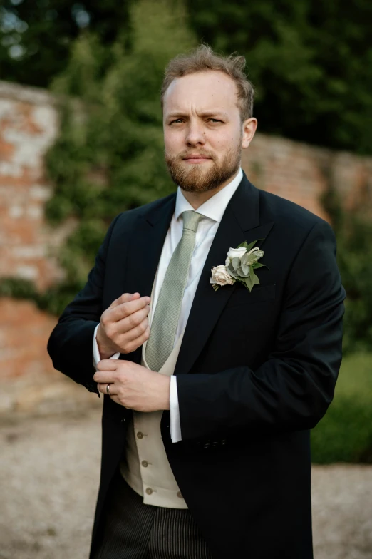 a man standing outside wearing a suit and tie