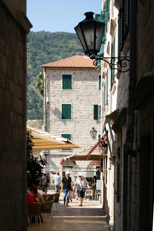 people are walking around on the street in an alley