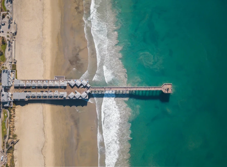 a beach with some sand and water at it