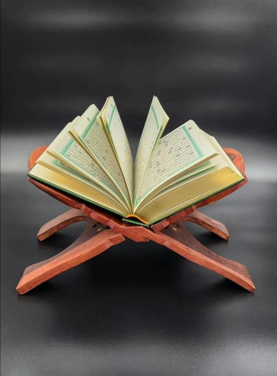 an open book is on top of a wooden stand