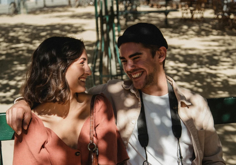 a man and woman sitting next to each other on a bench