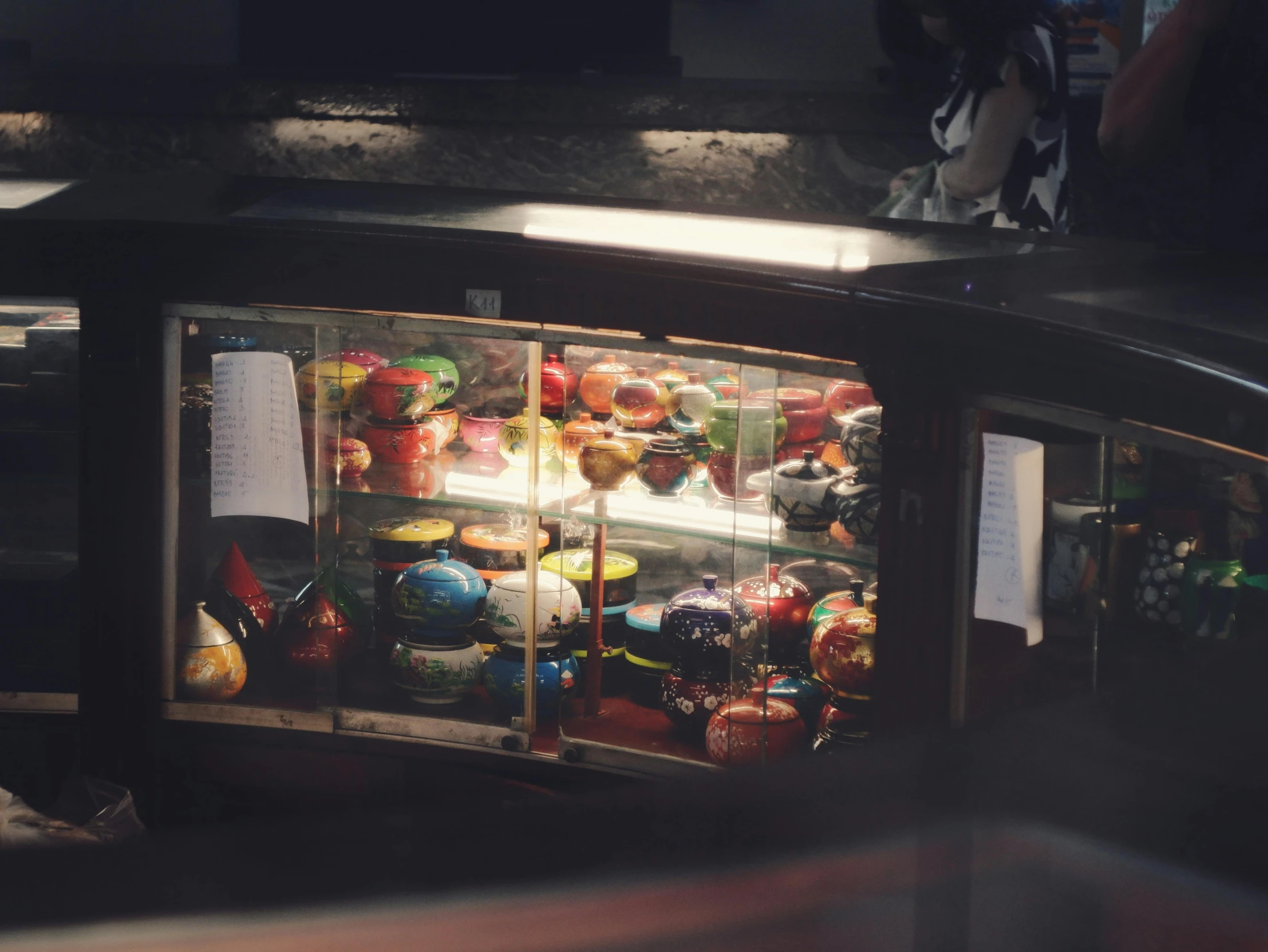 a small fridge is filled with many types of ornaments