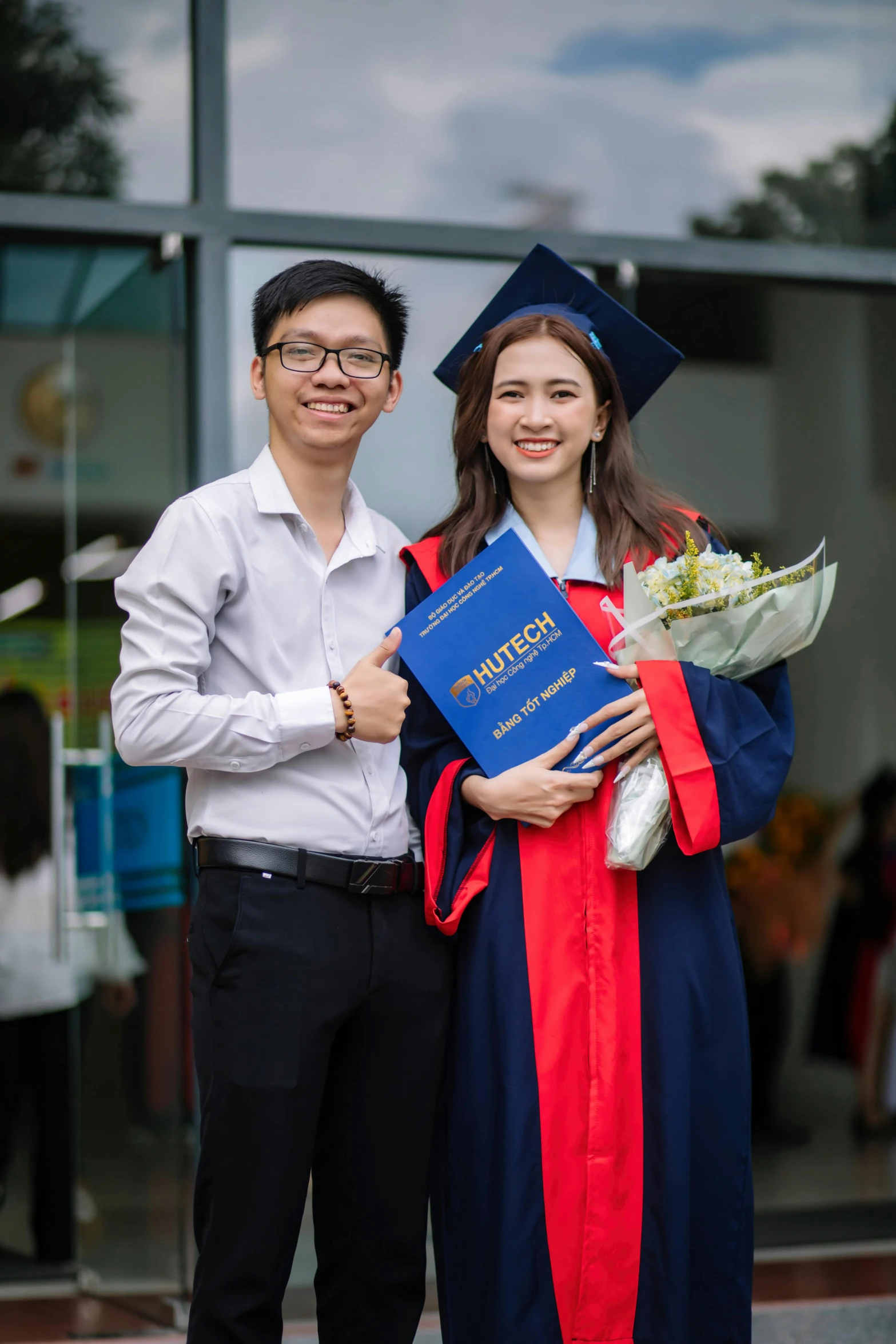 the young couple pose for the po while posing for the camera