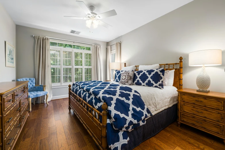 a bedroom with a bed sitting between two windows