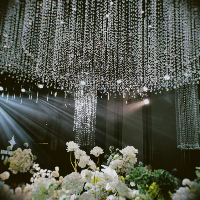 an image of a chandelier with white flowers and white flowers