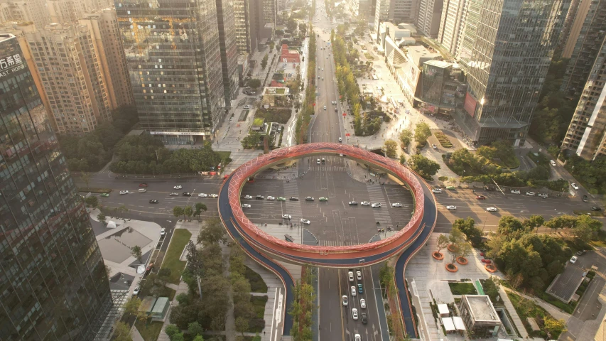 a very large circular building with many cars on the street