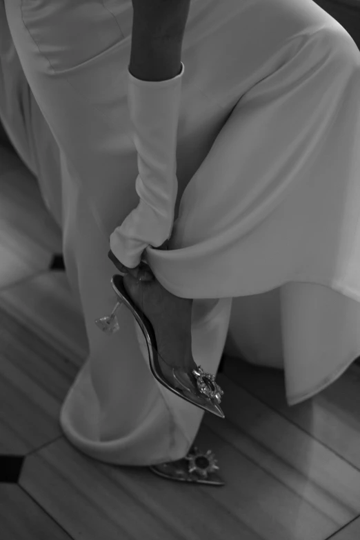 a woman sitting on a stair while wearing heels