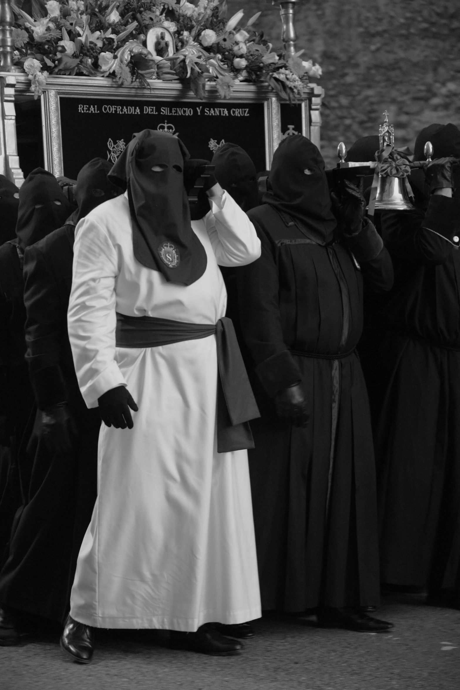 several people dressed in costume standing around a shrine