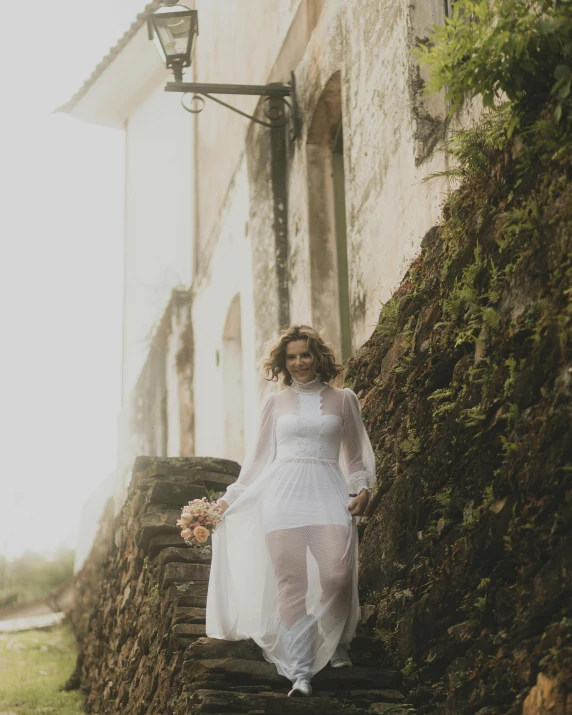 a woman standing on the steps of an old building