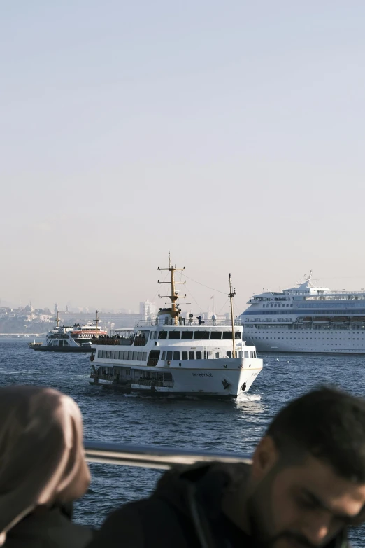 several boats are in the water next to each other