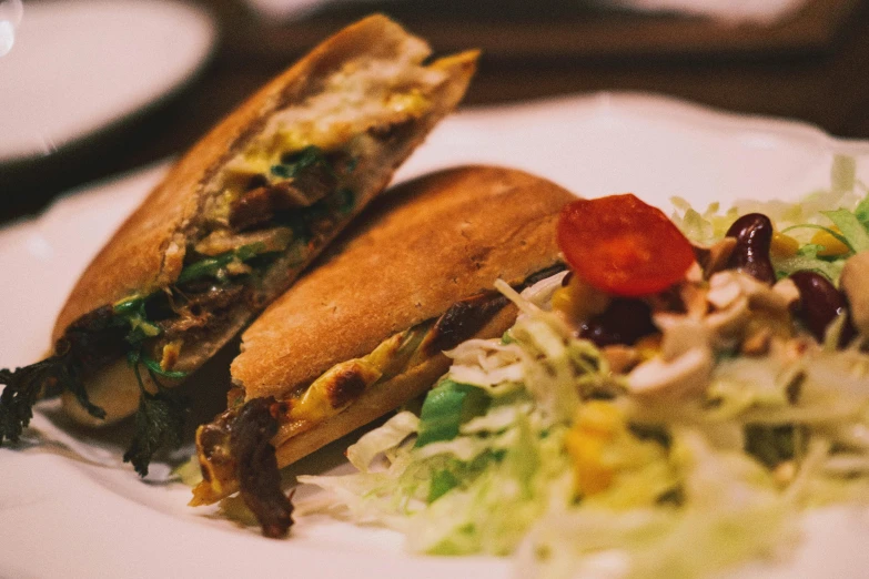 a plate with food and a sandwich on it