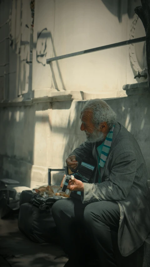 a man sitting down eating food on the ground