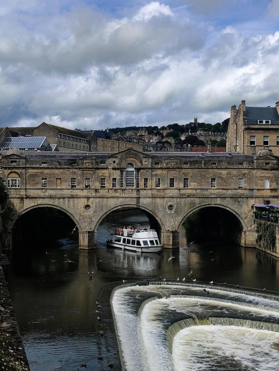 a large bridge over a river next to a tall building