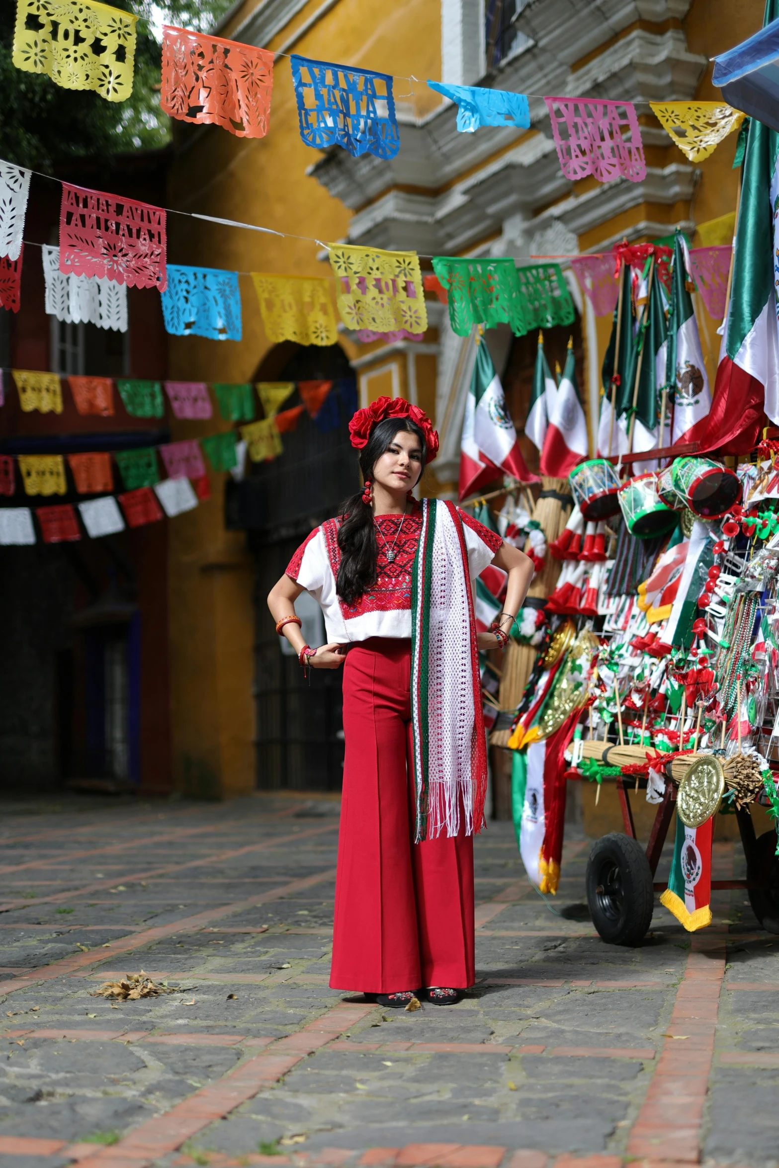 a person wearing a red dress and a large headpiece