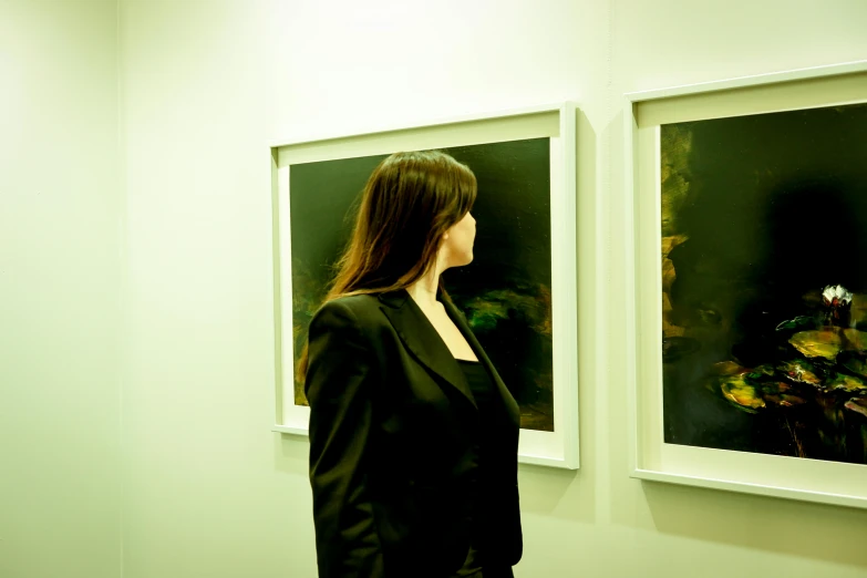 a woman that is standing in front of some pictures