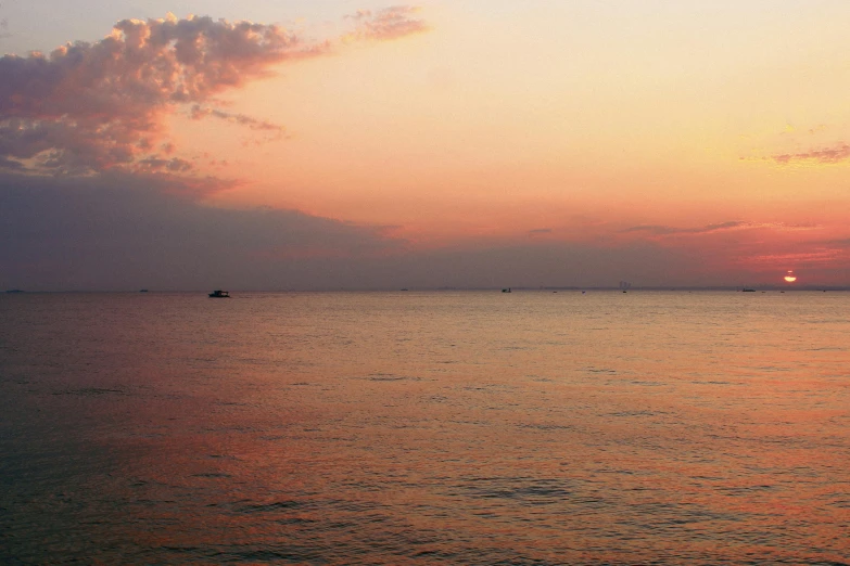 a large body of water sitting under a cloudy sky