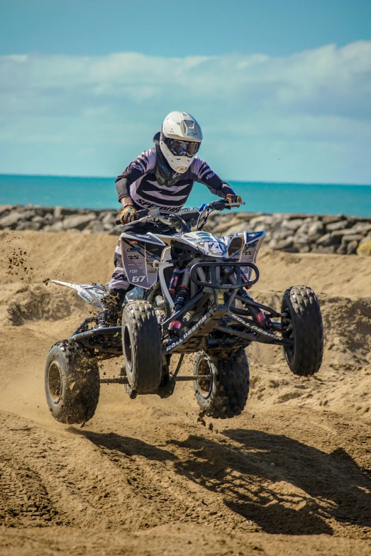 man riding atv with tires down the desert