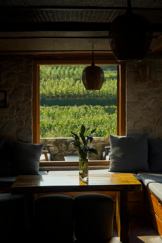 a table with chairs in front of a large window