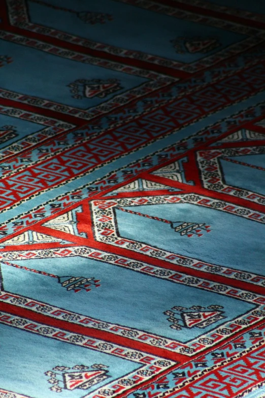 the carpet is blue and has intricate designs