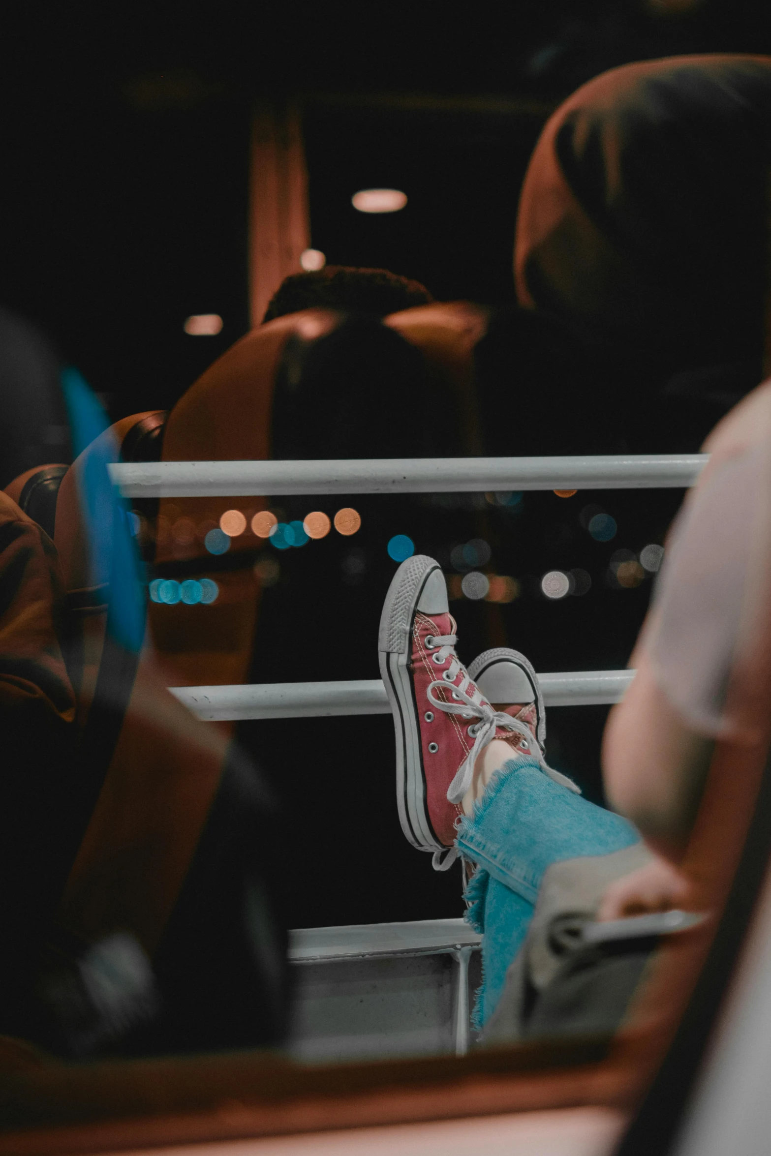 person sitting on a bus with their feet up