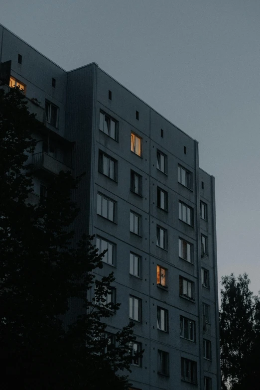 a tall building with several windows lit up