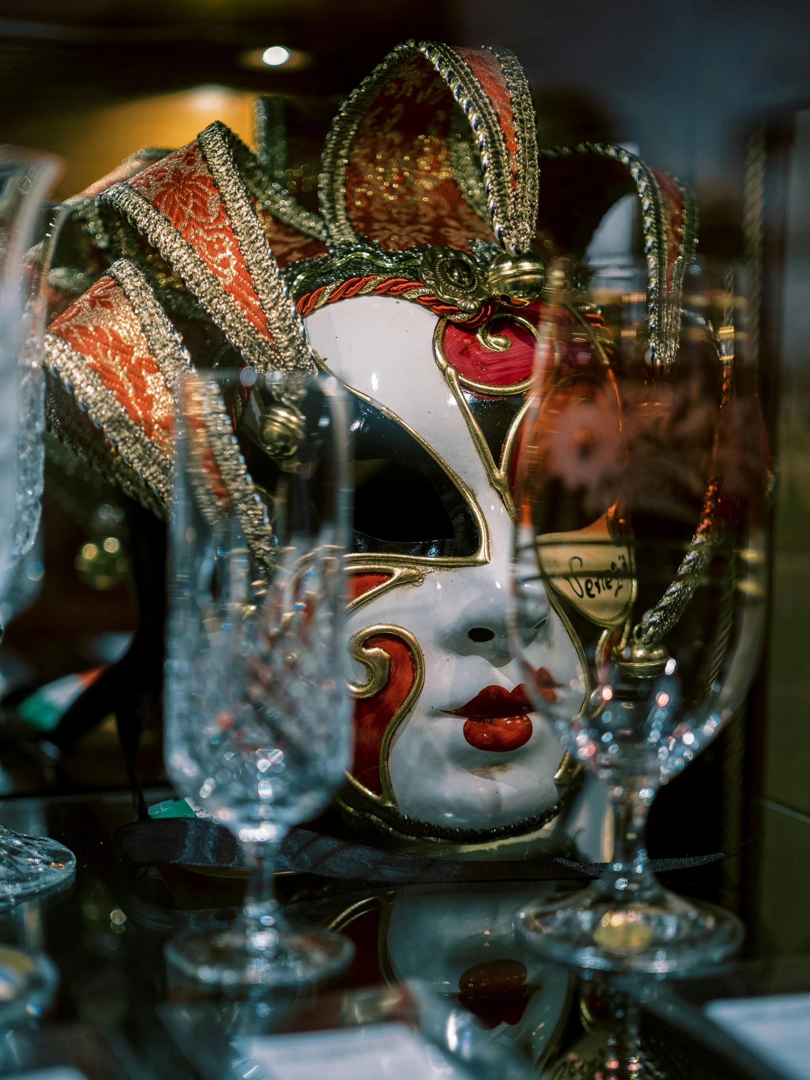 a mask on a table is next to glasses