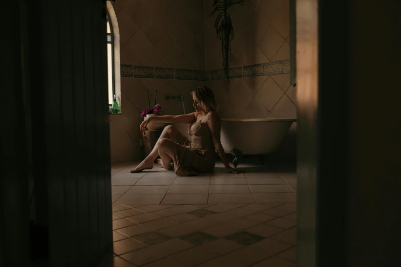 woman in lingerie sitting by tub with flowers in her hands