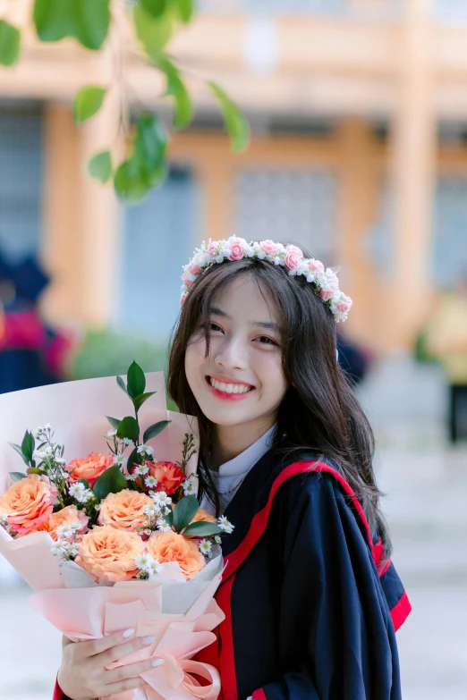 the young asian girl is smiling holding a bunch of roses
