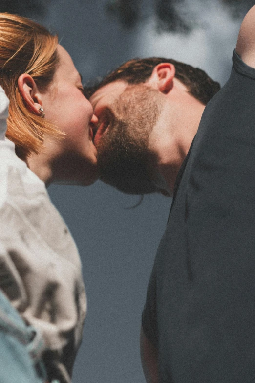 a couple are kissing while leaning together