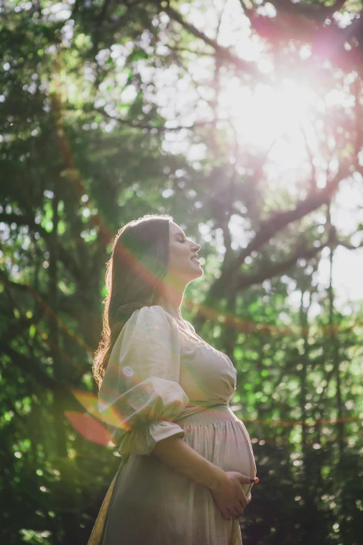 an image of a pregnant woman walking through the woods