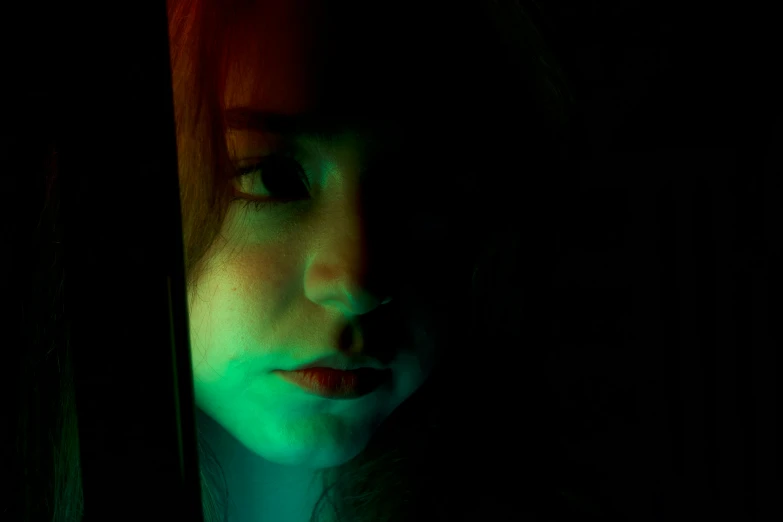 a girl looking out from behind the curtains