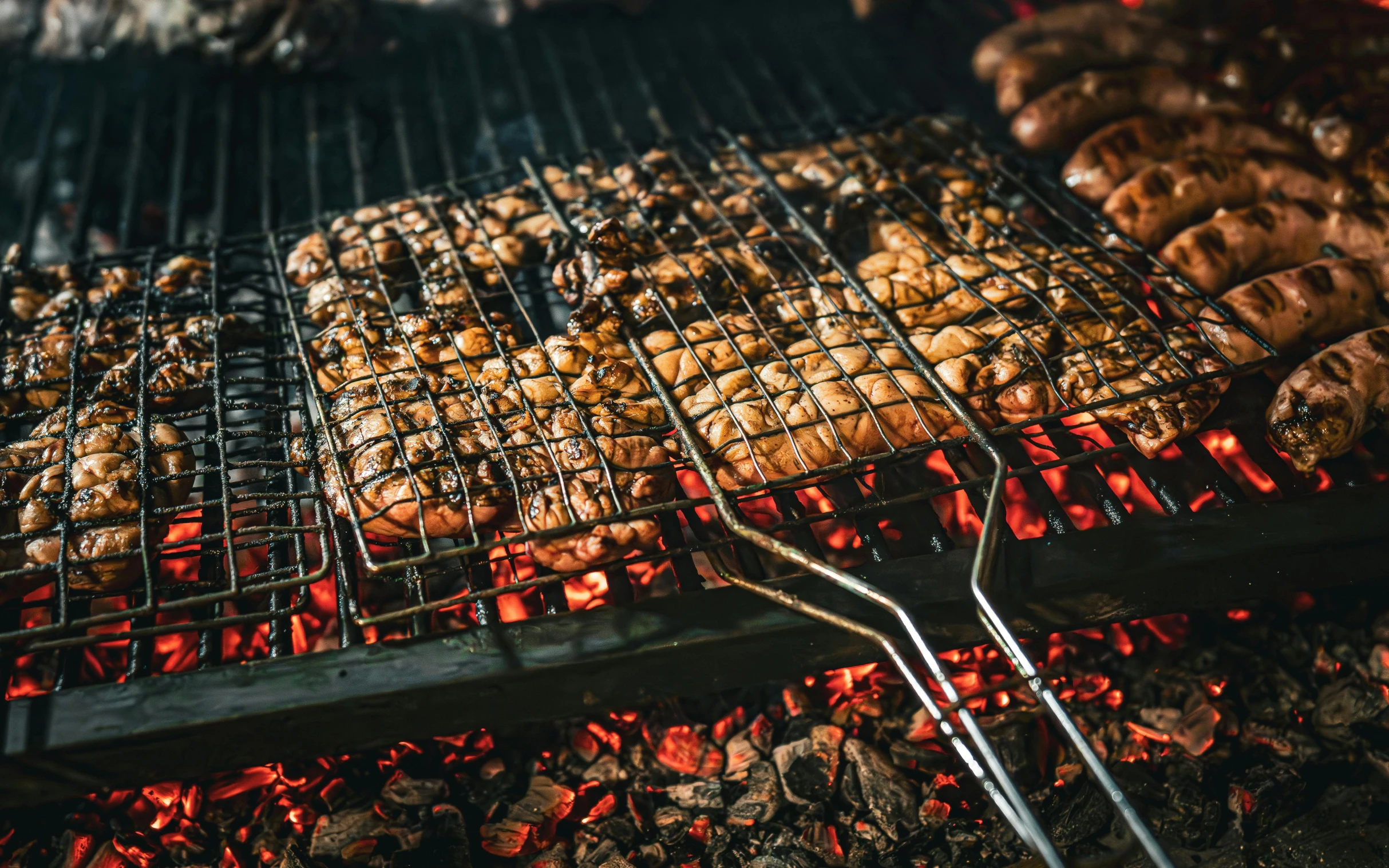 a bunch of food being cooked on top of a grill