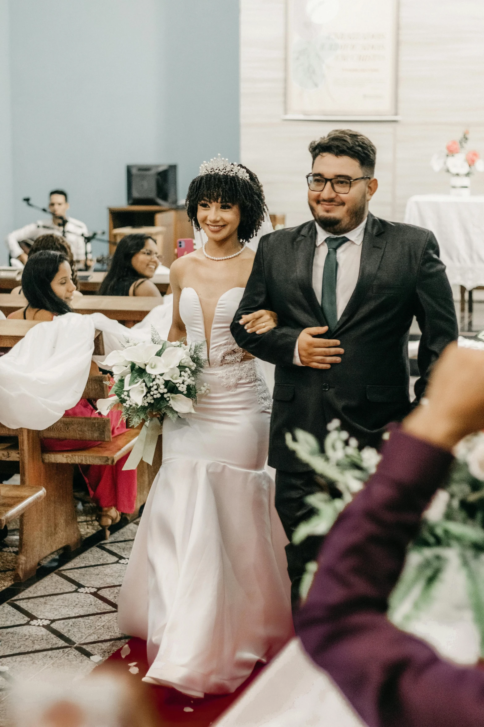 the bride is being escorted down the aisle