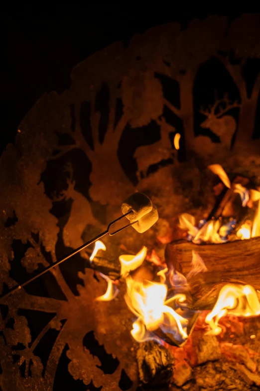 some flames sitting next to a clock and a piece of wood