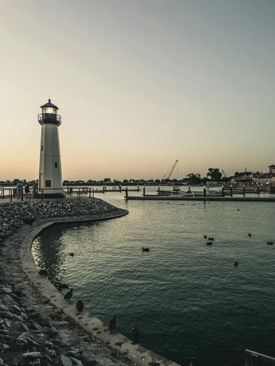 a light house sitting on the shore near a body of water