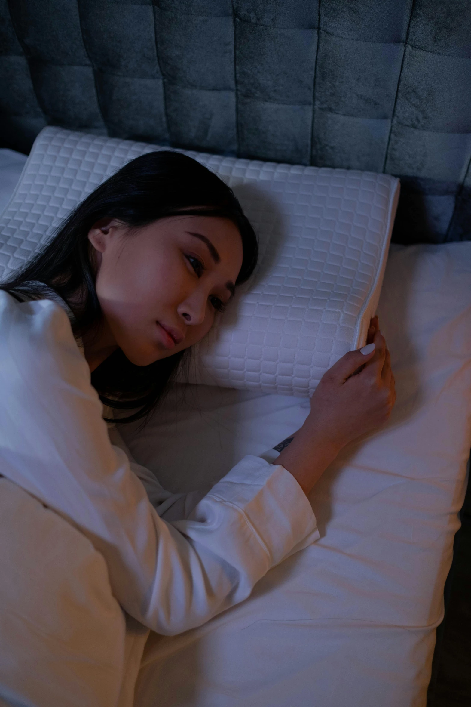 young lady sleeping on a bed in the evening