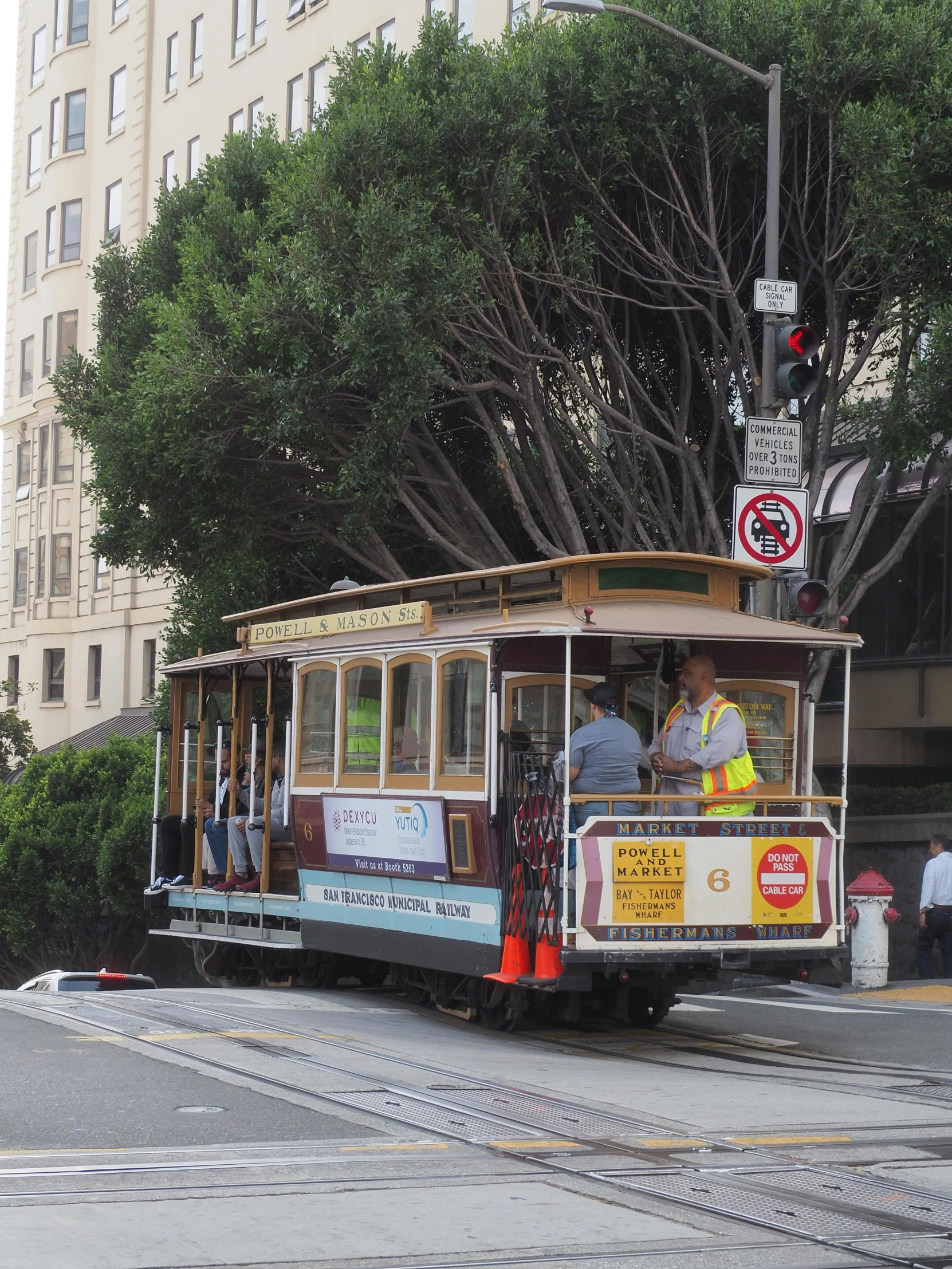 a cable car on a city street going through a city