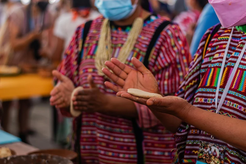 people are wearing face masks while clapping