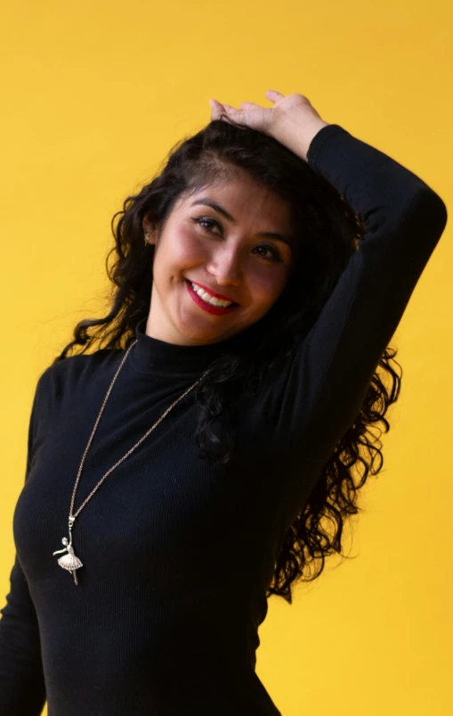 a girl poses for a picture with her hair in waves