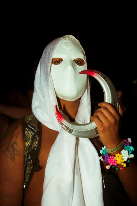 a woman is wearing a mask and holding a hoop