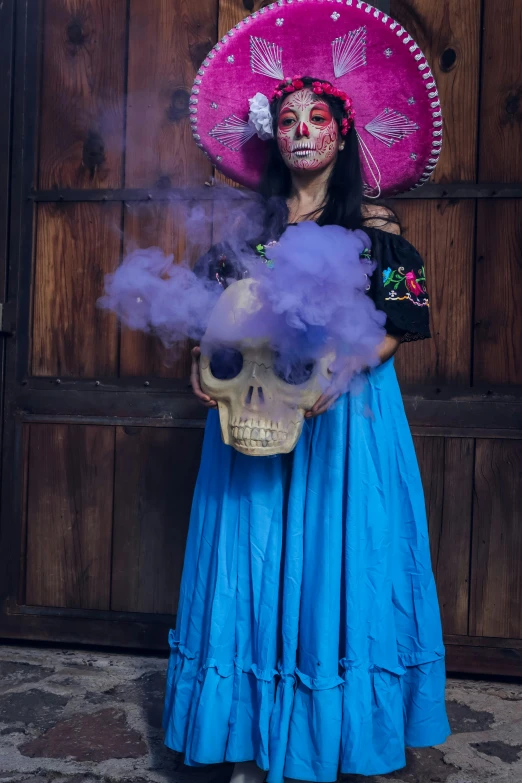 a person with makeup in a mexican costume and skull