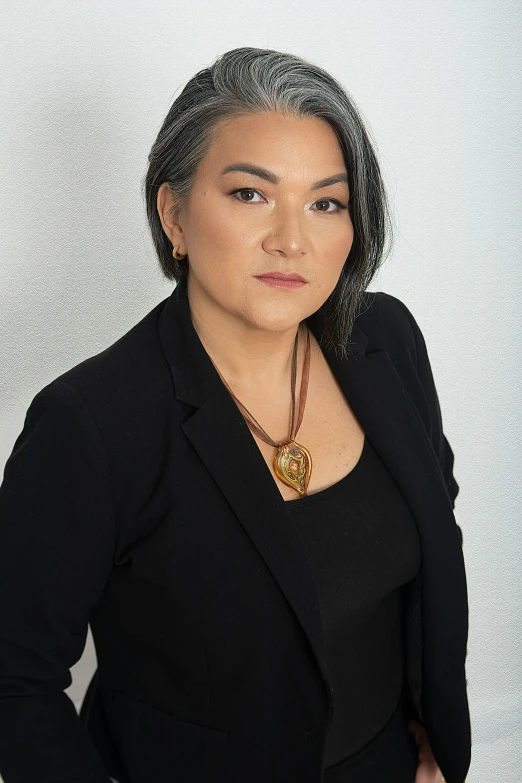 a woman standing up in front of a wall